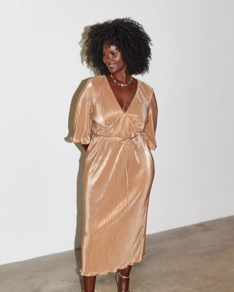 Front of a model wearing a size L Gold Plisse Dress in Gold by Never Fully Dressed. | dia_product_style_image_id:318770